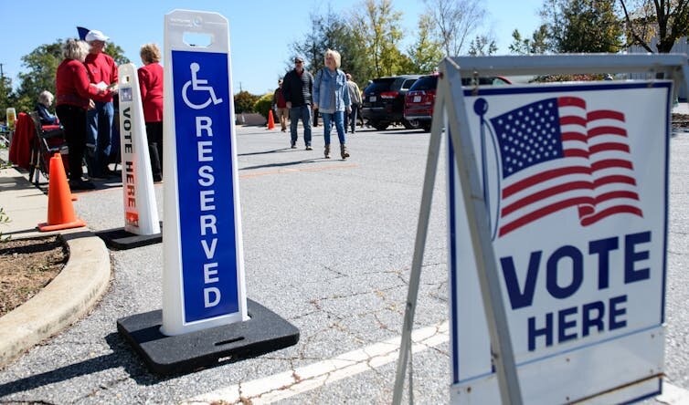 People walk into an early voting site in Hendersonville, N.C., on Oct. 17, 2024.