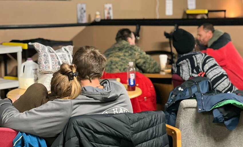 Unhoused Lewiston. Maine, residents huddle for the evening at the city’s new warming center.