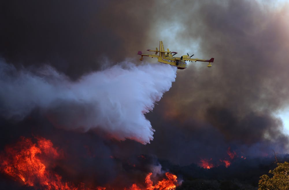 A firefighting plane dumps water on one of the fires in the Los Angeles area in January 2025.